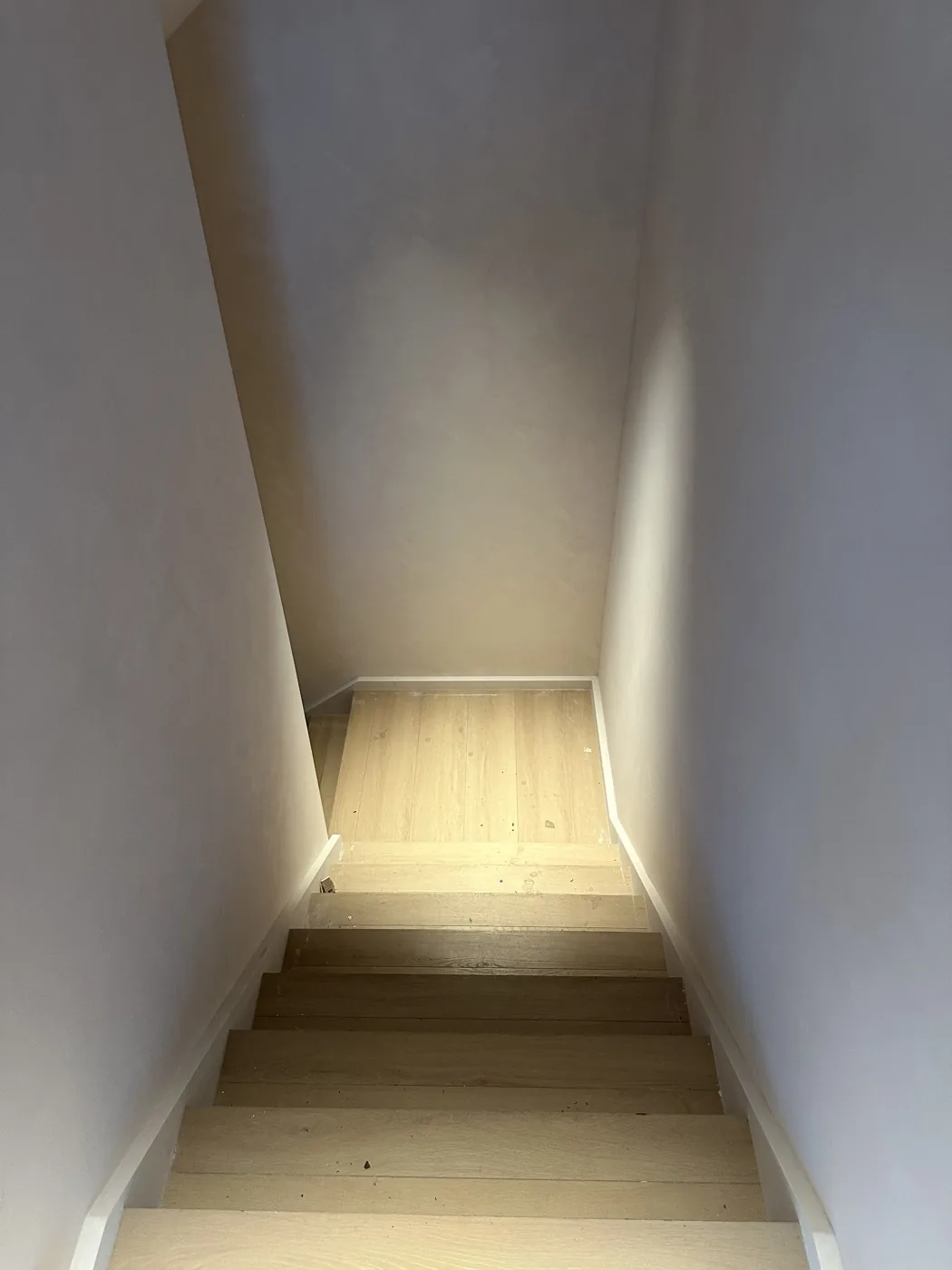 A timber staircase and painted walls after the final clean