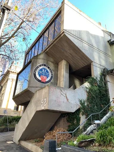 The PPTEU union building on Victoria Street, Melbourne. Brutalist concrete facade with the union emblem above the entrance.