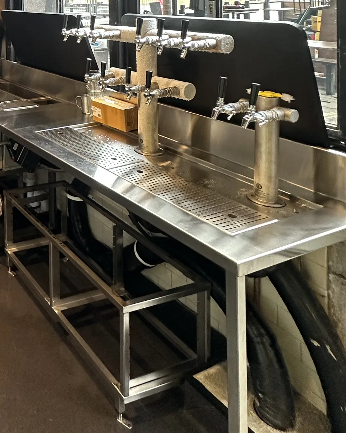 The same bar servery after the clean, with the stainless bench, drip trays and beer taps cleared